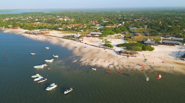 Drone aerial shot of Atins beach at Lencois Maranhenses, Maranhao, Brazil. Kite surfers surfing and enjoying.
