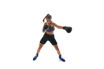 Dynamic image of athletic young woman in motion, training, boxing athlete fighting isolated on...