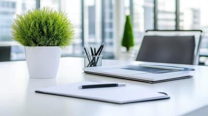 Minimalist office desk with laptop and notebook
