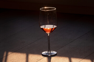 Glass of red wine on the shaded floor