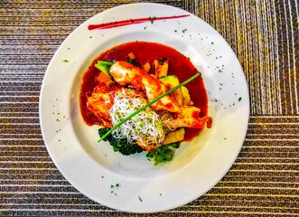 White plate with a chicken vegetable potato dish in Mexico.