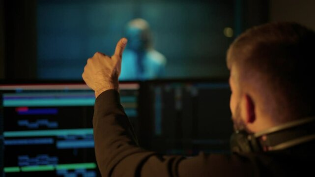 Male studio engineer showing OK symbol to woman singer in recording studio. Professional musicians working together in modern record label, creating new single for music album, talented people team