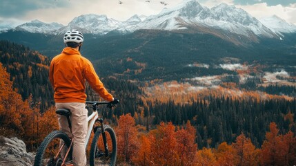 Fototapeta premium Mountain biker, nature athlete, nature person, watching the magnificent view of the mountains and forest