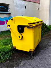 Trash cans are full. Yellow trash bin, plastic trash can, solid waste.