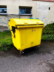 Trash cans are full. Yellow trash bin, plastic trash can, solid waste.