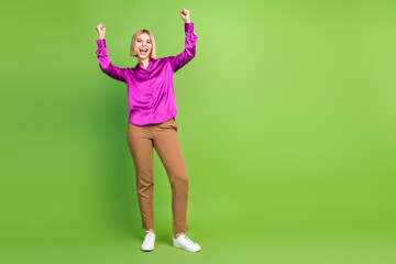 Photo of overjoyed glad girl wear stylish pink clothes empty space isolated on green color background