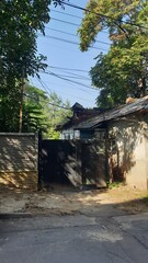 Moldova, Chisinau, capital, rain, puddle, gate, street, monument, building, architecture, antiquity, door, restoration, trees, leaves, autumn, flowerbed, flowers, berries, porch, steps, columns