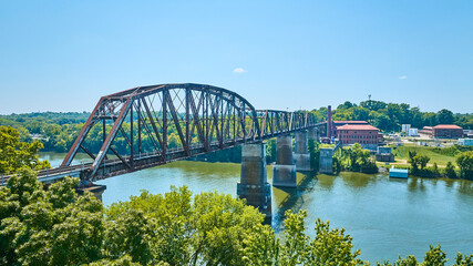 Fototapeta premium Aerial of Rusted Railway Bridge Over River in Nashville Industrial Heritage