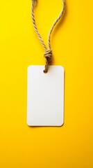 white blank tag on rope against yellow