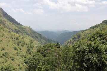 Fototapeta premium Mountain panorama in forest and blue sky. Wonderful view over asian rainforest