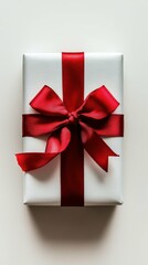 Overhead view of a Christmas gift box with a ribbon, against a plain white background