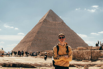 man in front of the great pyramids of Giza