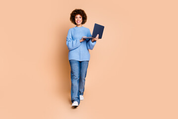 Full size photo of optimistic girl with chevelure dressed blue sweater holding laptop read email isolated on pastel color background