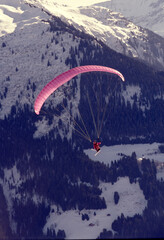 Adventurous Paragliding Over Snowy Mountains