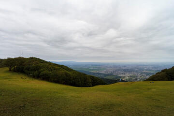 Grass prairie with Argentine flag and city of San Miguel de Tucumán in the background