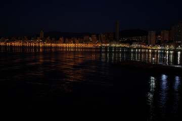 Fototapeta premium Night Aerial photo of Benidorm Playa Levante beach, hotels, buildings, restaurants and the coastline and sandy beaches of Benidorm the seaside resort in Spain Alicante.