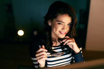 Smile, night and portrait of woman in office with computer, glasses and confident attitude. Pride,...