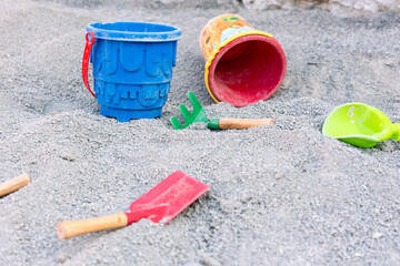 children toys in the sand, digger, bucket, spade 