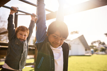 Children, portrait and swing on monkey bars, playing together and friends at park for fun. Kids, boys and games on jungle gym playground for childhood, energy and students for freedom at recess