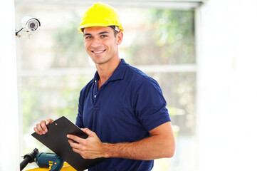 happy cctv camera technician. close-up of Technician Installed Camera On Wall.