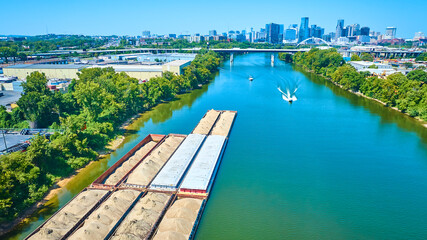 Aerial View of Sand Barges on Nashville River with Cityscape Backdrop