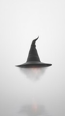 Fototapeta premium A black witch hat levitates above a white background with a hazy glow emanating from its base.