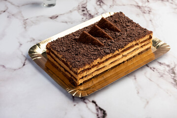 sweet dessert choco cake with chocolate cookies dulce de leche cream cheese on kitchen counter decorated with broken chocolate