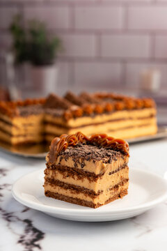 sweet dessert choco cake with chocolate cookies dulce de leche cream cheese on kitchen counter decorated with broken chocolate