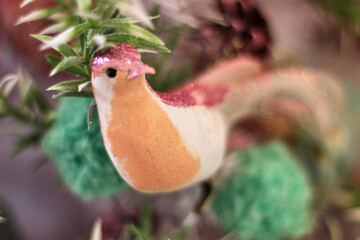 small Christmas tree made of white needles decorated with roses and birds in pink colors in romantic style