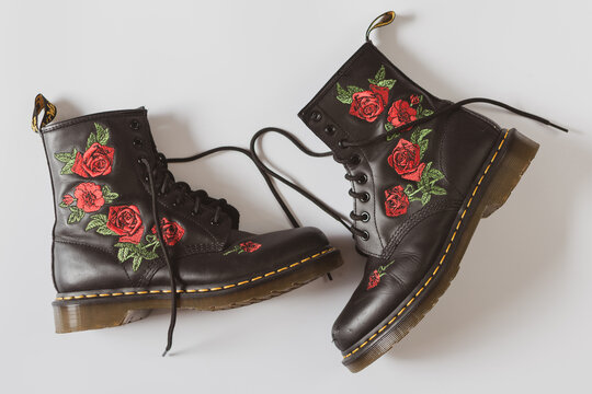 stylish photo of doctor Martens 1460 Vonda boot with roses - black leather doc Martens for women - white background with copy space 