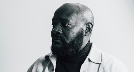 Thoughtful portrait of bearded man in monochrome lighting