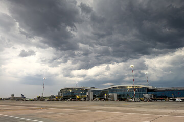 Otopeni Henri Coanda Airport in Romania. Wide angle photo with a stormy clouds landscape over...