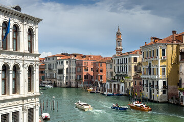 Obraz premium Gondola photo in Venice. Beautiful video with touristic taxi and local gondola boats cruising on the channels of Venice. Landmark landscape view of Italy.