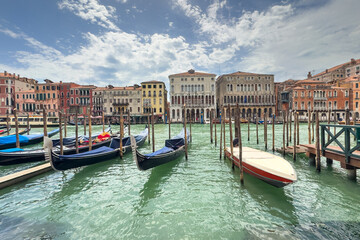 Obraz premium Gondola photo in Venice. Beautiful video with touristic taxi and local gondola boats cruising on the channels of Venice. Landmark landscape view of Italy.