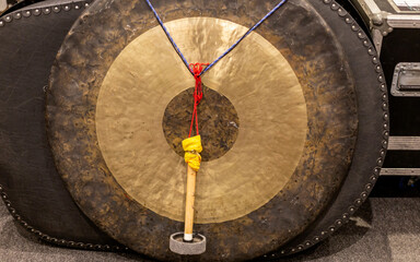 Close-up image of a gong with a mallet resting against it, with Zildjian logo visible at the center.