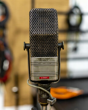 Vintage RCA microphone on a stand with a blurred background.