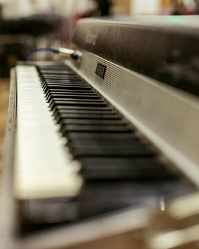 Close-up view of an electronic keyboard with shallow depth of field, focusing on the keys.