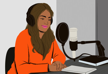 Woman in orange sweatshirt recording a podcast with headphones and microphone in a studio setting.