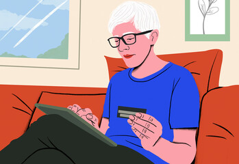 Adult holding a credit card and using a tablet on a red sofa indoors.