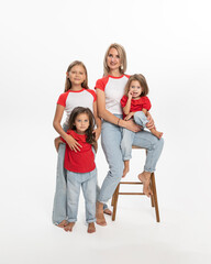 Happy family mom with her daughters, posing in studio. Copy space.