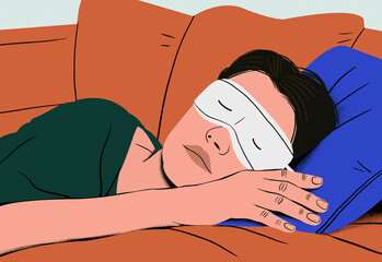 Woman sleeping peacefully on a couch with a sleeping mask on.