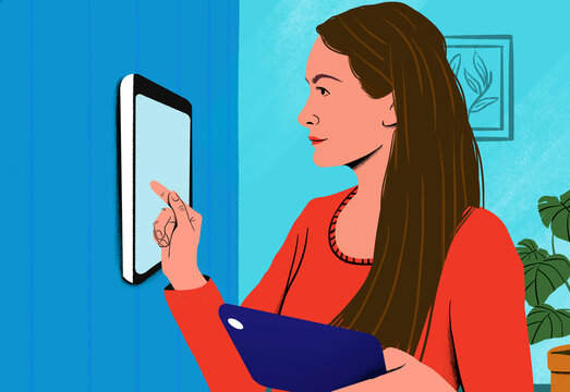 Woman using a touchscreen interface on a wall-mounted digital device in a modern home setting.