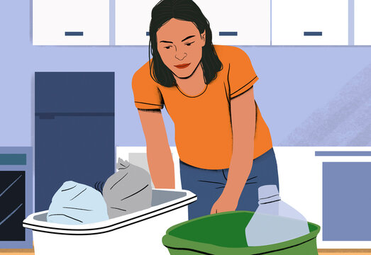 Woman folding laundry in a bright room with a bottle of detergent and a green laundry basket.