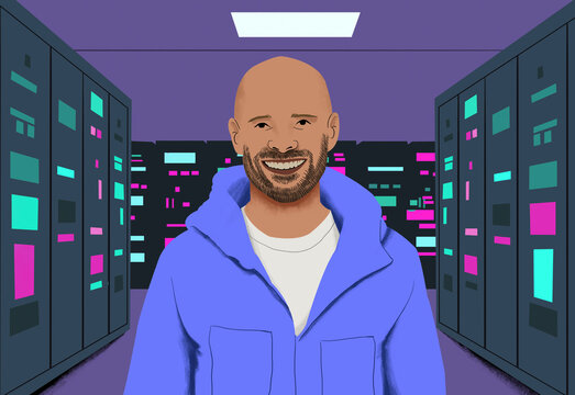 Smiling man in a blue jacket standing in a data center with server racks illuminated by multicolored lights.