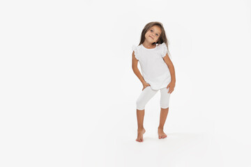 Full length image of a little girl posing in a white clothes, isolated white background. © Corina