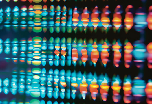 Abstract colorful background with blurred light patterns forming a vibrant moire effect.