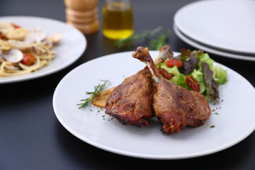 Duck leg confit with sauce. isolate in white background. top view. Duck confit on white plate