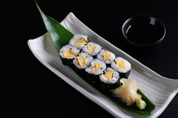 Tamago Maki roll, Traditional Japanese food Maki Tamago isolate in black background