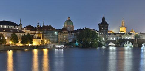 Panoramic night view of the iconic Charles Bridge over Vltava river and Prague Old town cityscape, in Prague, Czech Republic