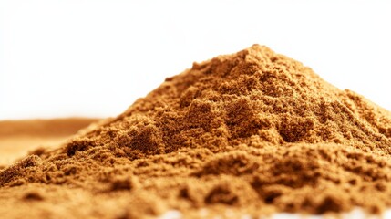 Close-up of a brown powder heap on a white background, highlighting texture and details. Perfect for food, spice, and ingredient-related concepts.